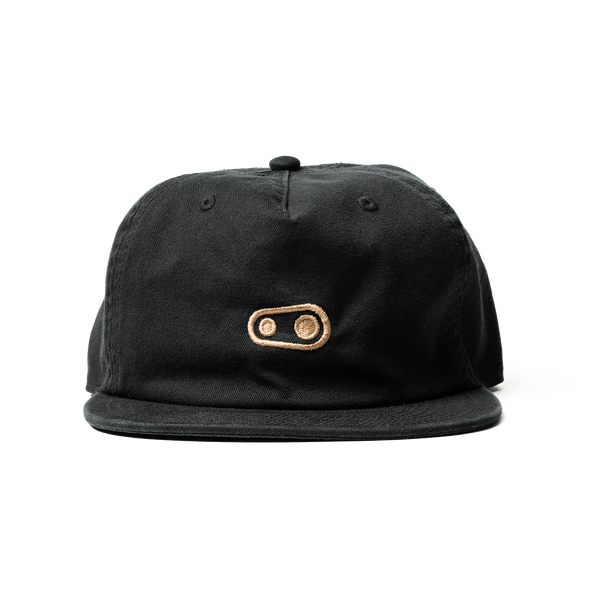Black cap with a gold logo on a white background