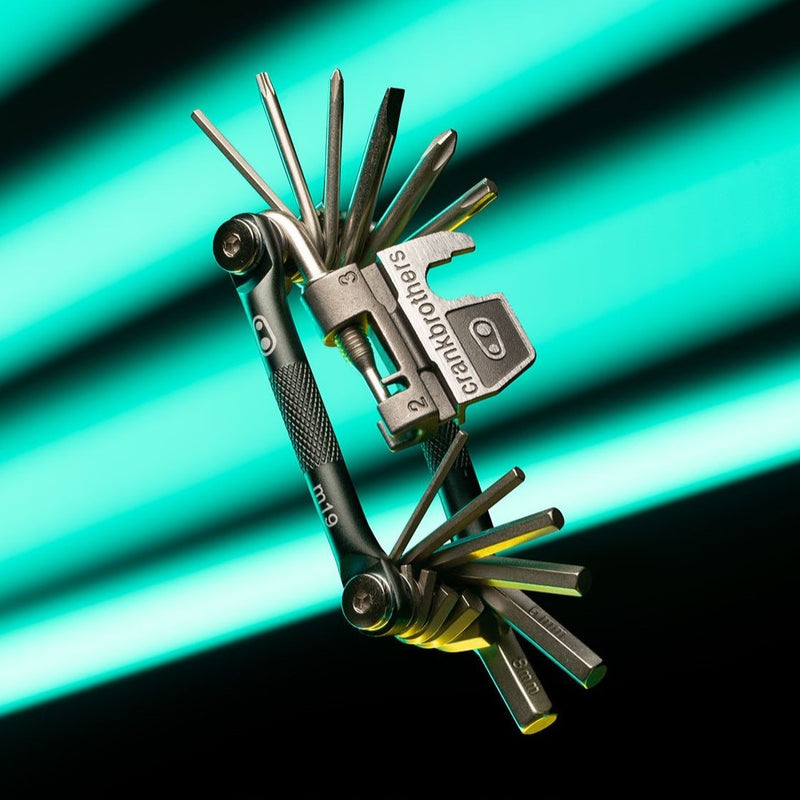 black mtb multitool floating on blue and black background